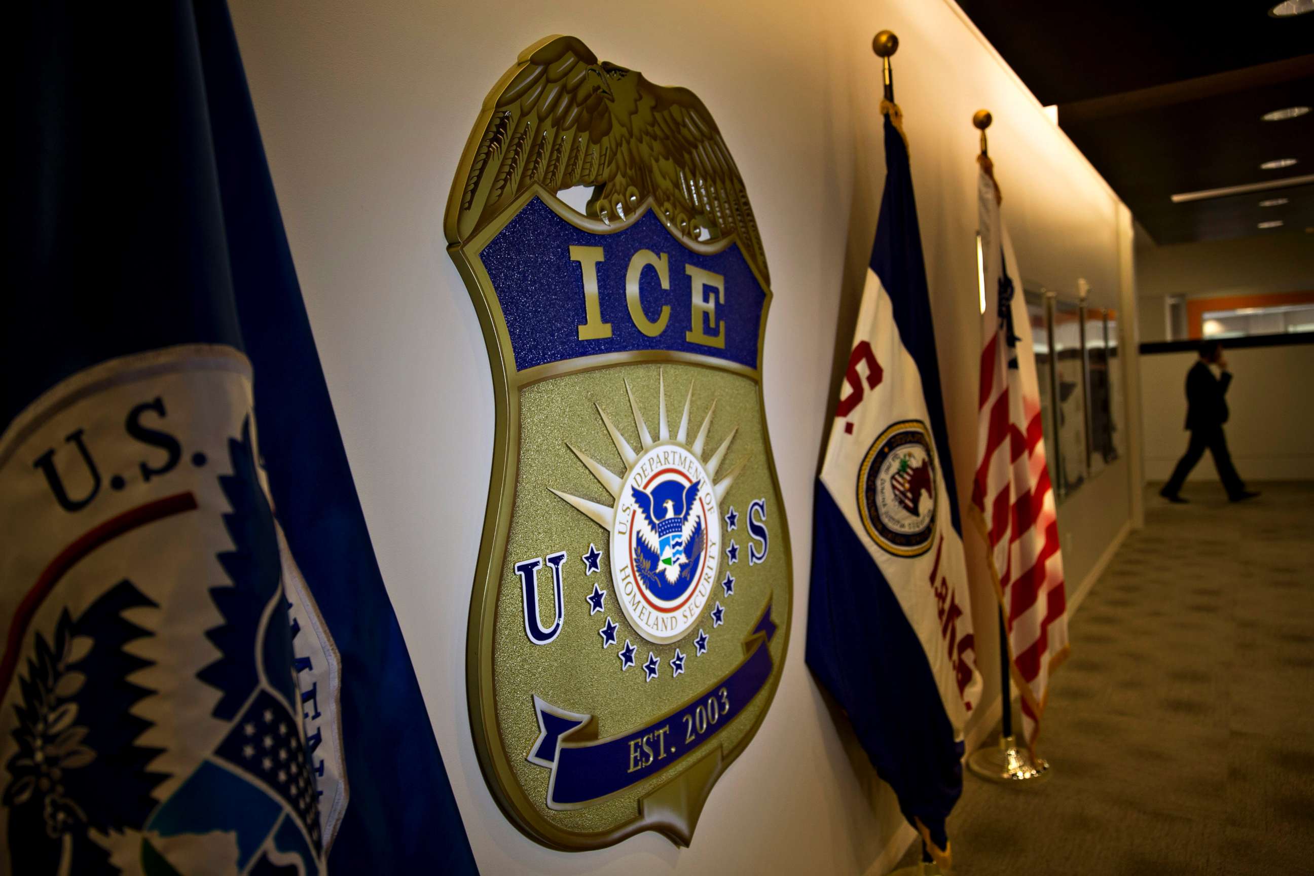 PHOTO: The U.S. Immigration and Customs Enforcement (ICE) seal hangs on a wall at the headquarters in Washington, D.C., on Nov. 20, 2014. 