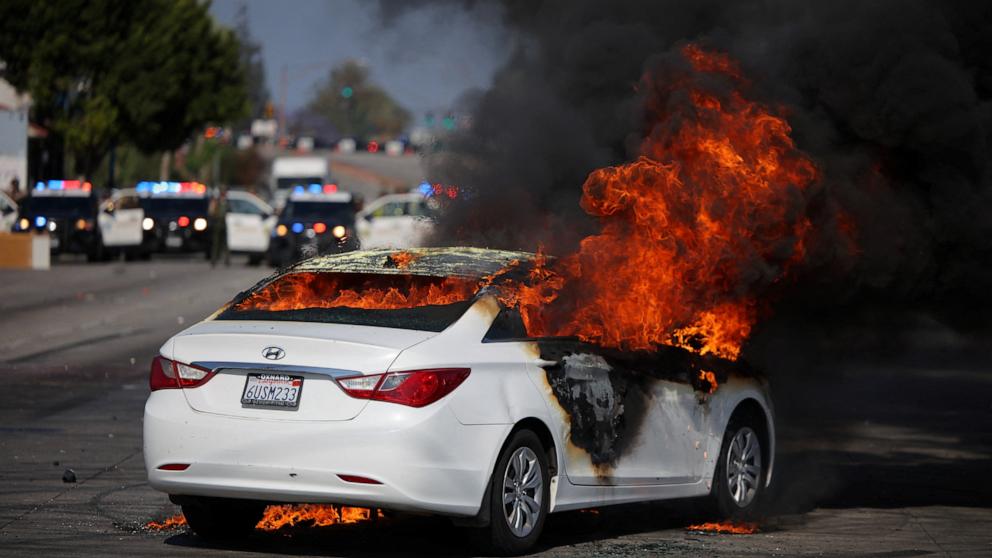 PHOTO: A car burns in flames following multiple detentions by Immigration and Customs Enforcement in the Los Angeles County city of Paramount, Calif., June 7, 2025.