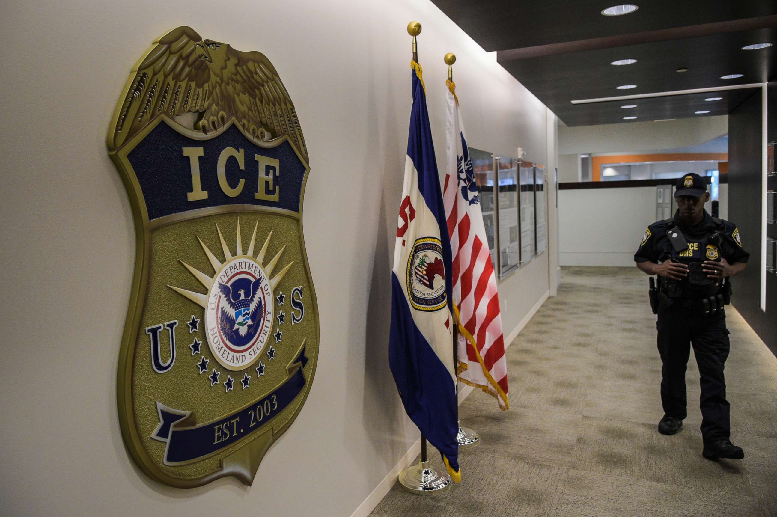 PHOTO: A law enforcement officer walks past ICE logo ahead of a press conference at the U.S. Immigration and Customs Enforcement headquarters, May 11, 2017, in Washington, D.C.