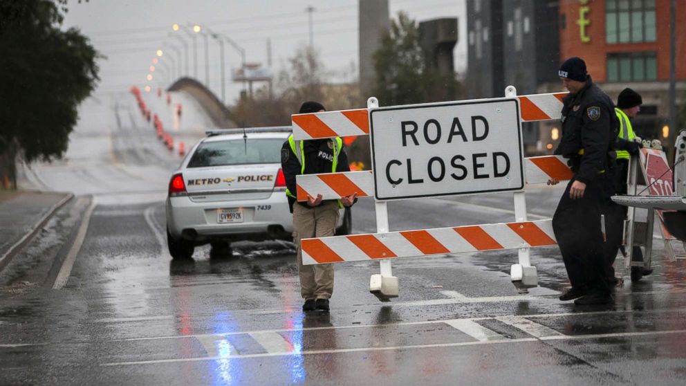 PHOTO: Two Savannah Chatham Metro Police officers set up a barricade in front of a bridge that was closed due to ice on the road, Jan. 3, 2018, in Savannah, Ga. 