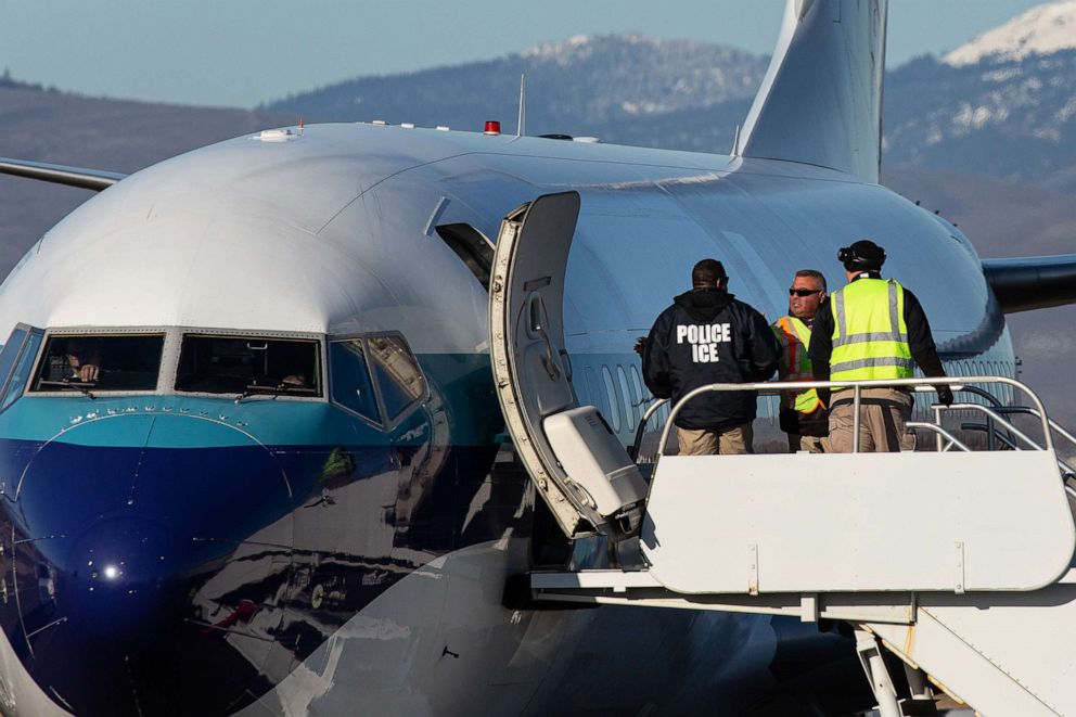 PHOTO: Agents working for U.S. Immigration and Customs Enforcement (ICE) prepare to board detainees onto a Swift Air charter flight at McCormick Air Center on February 18, 2020, in Yakima, Wash.