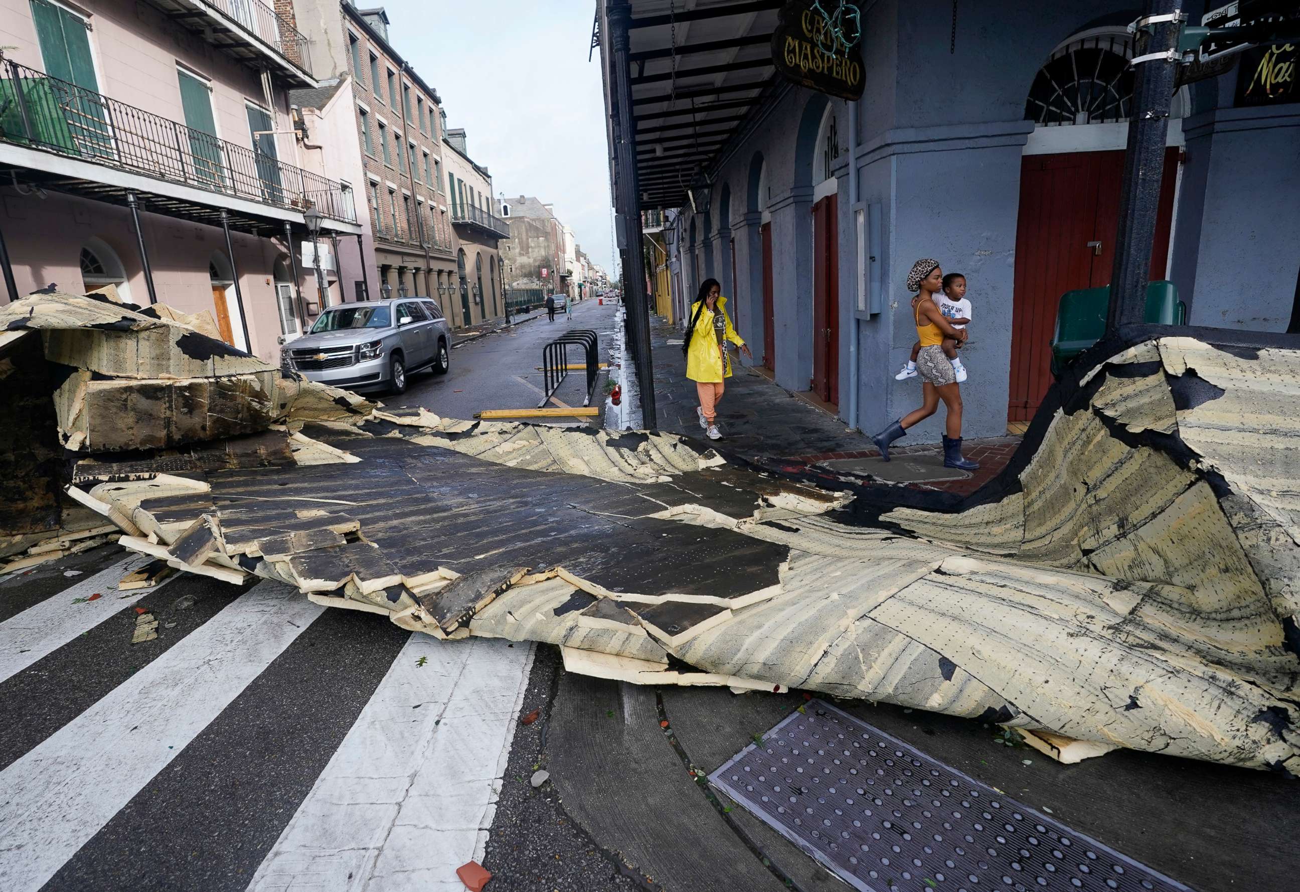 PHOTO: A section of roof that was blown off of a building in the French Quarter by Hurricane Ida winds blocks an intersection, Aug. 30, 2021, in New Orleans.