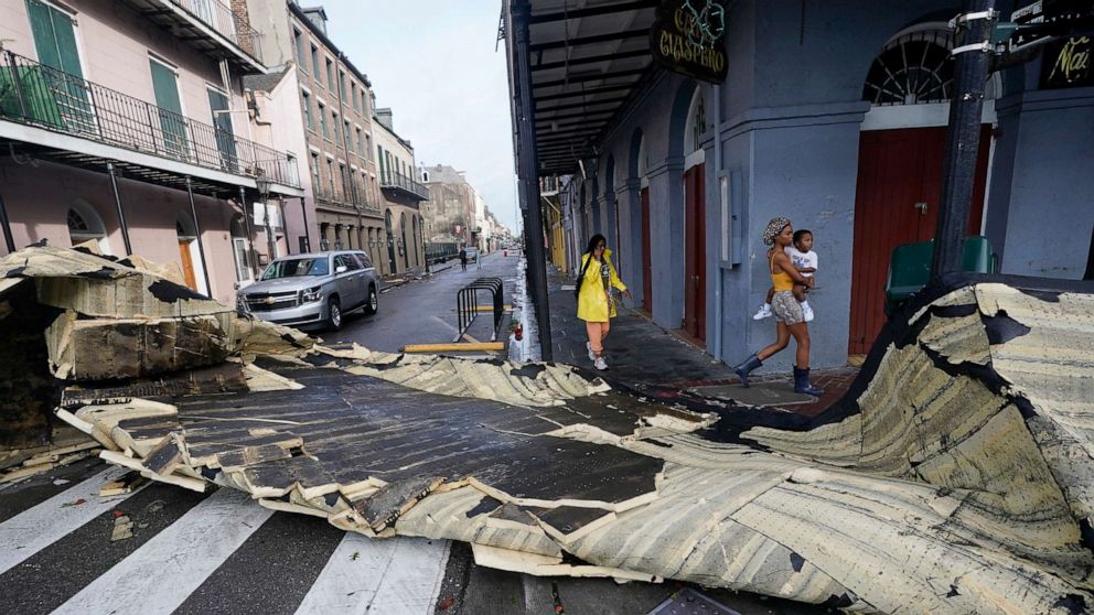 PHOTO: A section of roof that was blown off of a building in the French Quarter by Hurricane Ida winds blocks an intersection, Aug. 30, 2021, in New Orleans.