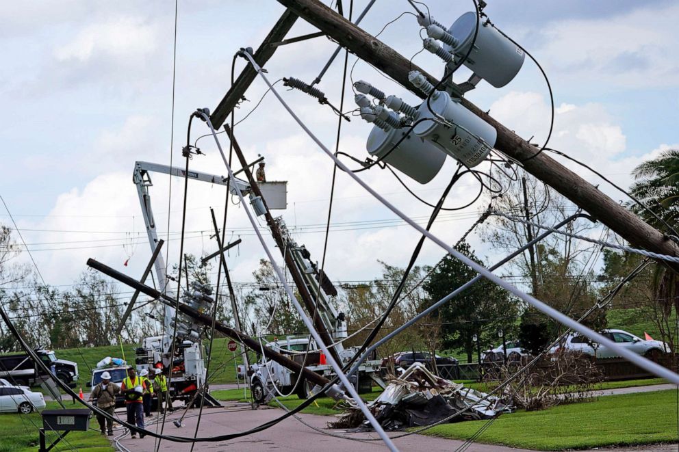PHOTO: Crews begin work on downed power lines leading to a fire station, Aug. 31, 2021, in Waggaman, La., as residents try to recover from the effects of Hurricane Ida.