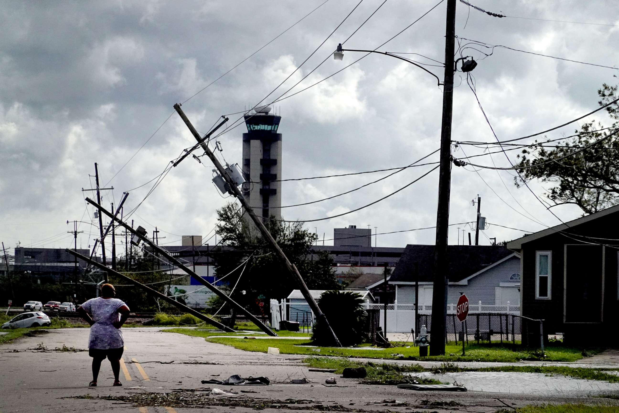 PHOTO: A woman looks over damage to a neighborhood caused by Hurricane Ida, Aug. 30, 2021, in Kenner, La. 