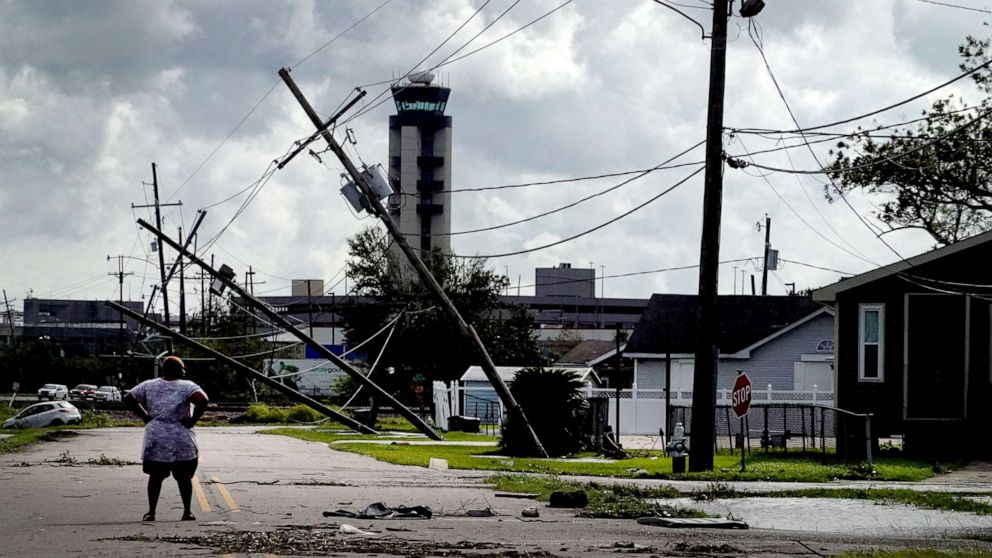 PHOTO: A woman looks over damage to a neighborhood caused by Hurricane Ida, Aug. 30, 2021, in Kenner, La. 