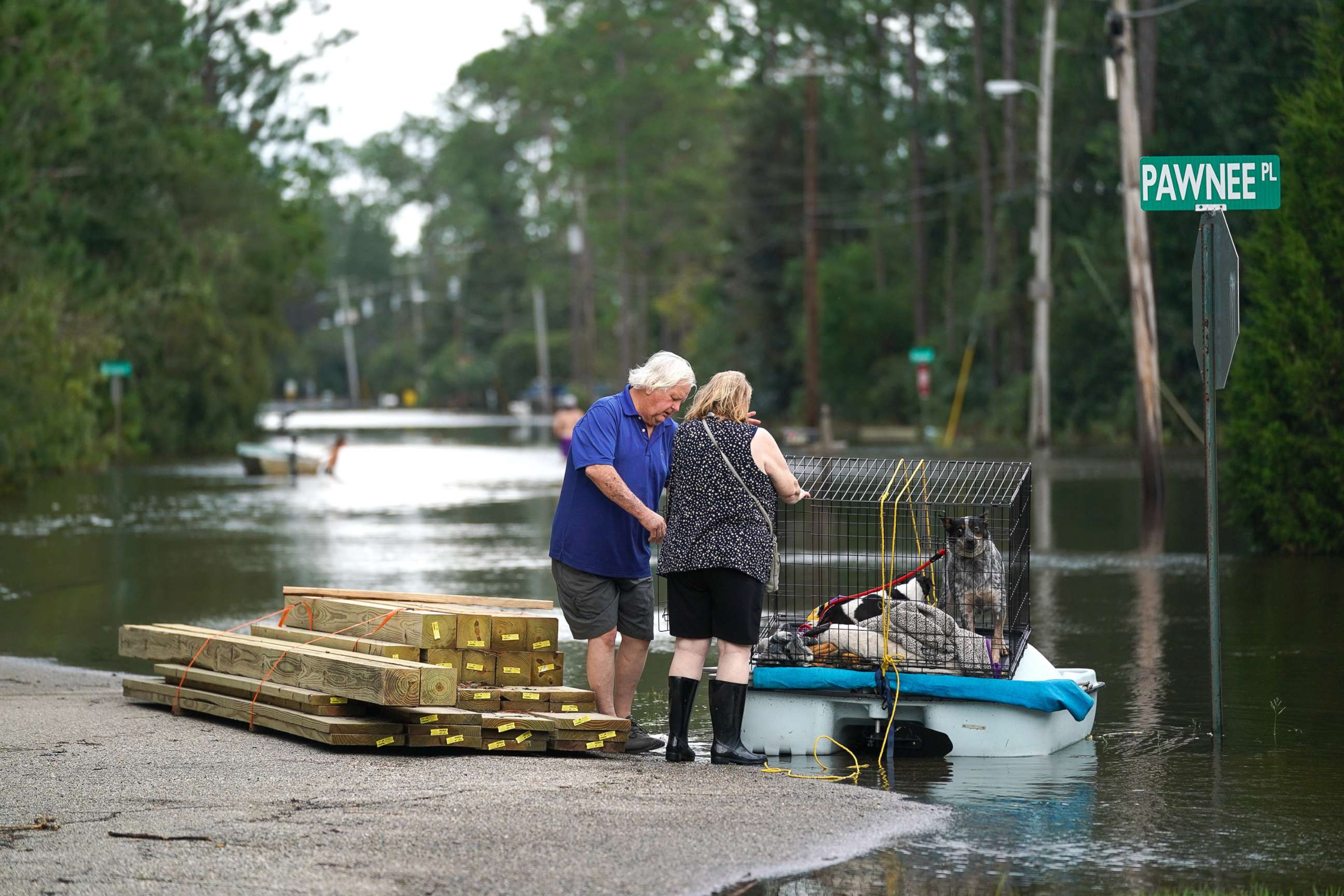 PHOTO: A couple uses a paddle boat to transport their dogs through a flooded neighborhood on Aug. 30, 2021 in Kiln, Miss.