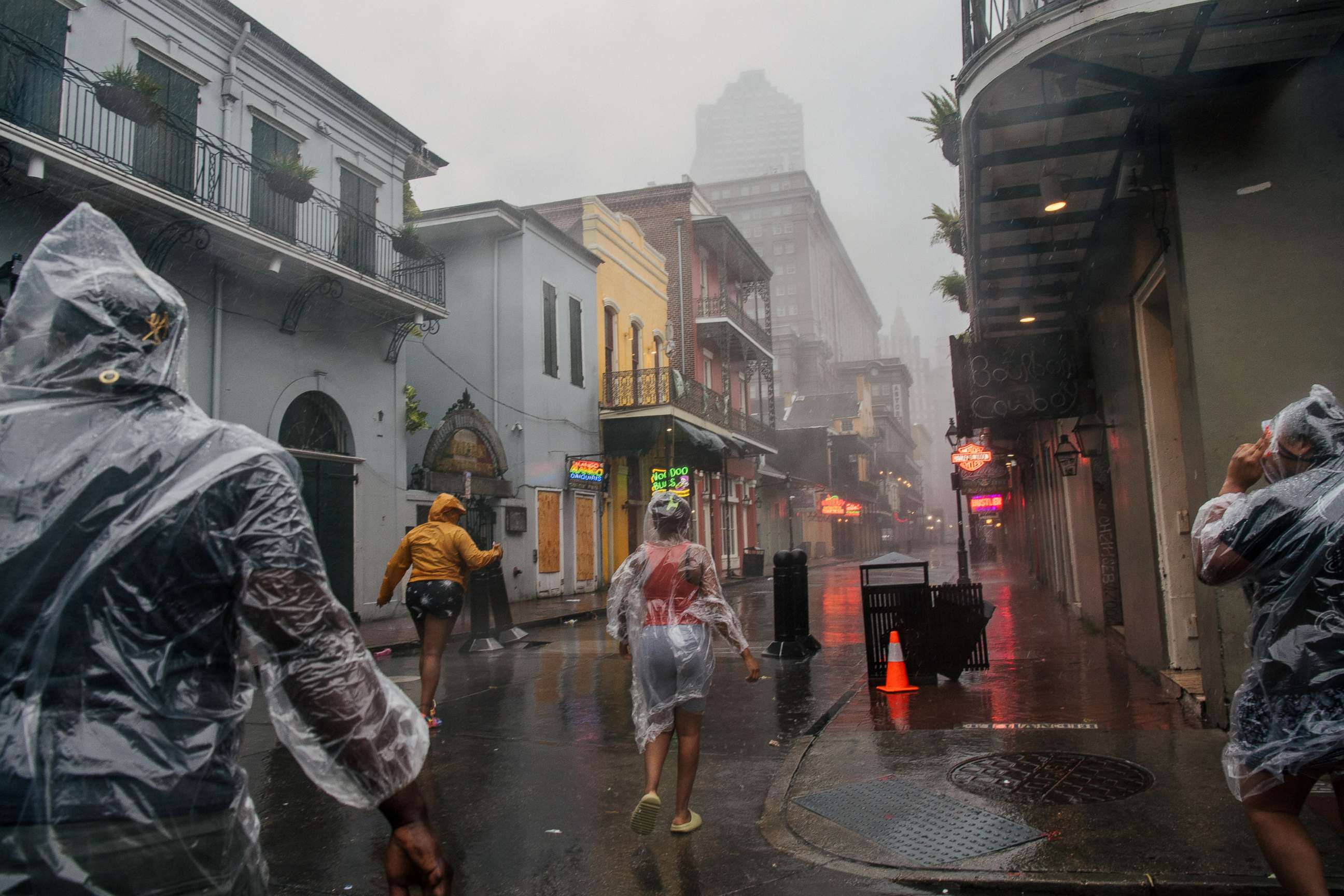 PHOTO: A group of people walk through the French District during Hurricane Ida, Aug. 29, 2021 in New Orleans.