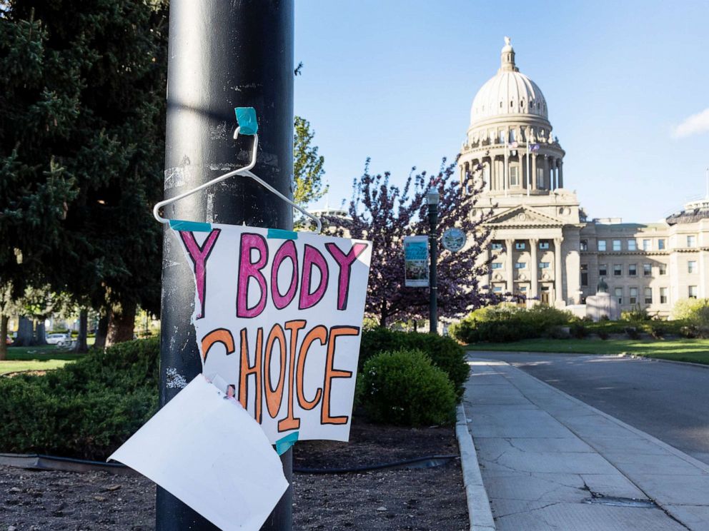 PHOTO: A torn sign reading My body my choice on a hanger hangs on a streetlight in front of the Idaho State Capitol Building, May 3, 2022.