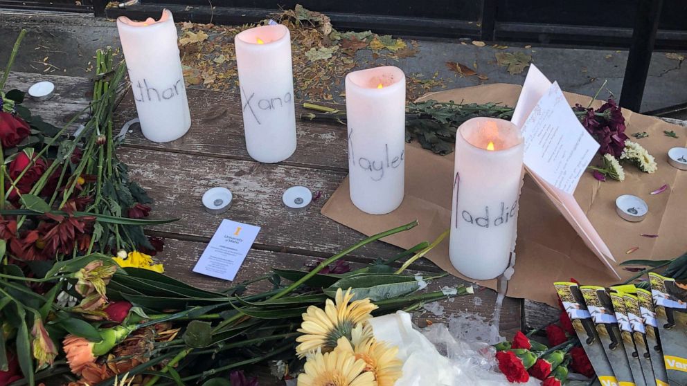 PHOTO: Candles and flowers are left at a make-shift memorial honoring four slain University of Idaho students outside the Mad Greek restaurant in downtown Moscow, Idaho, on Tuesday, Nov. 15, 2022.