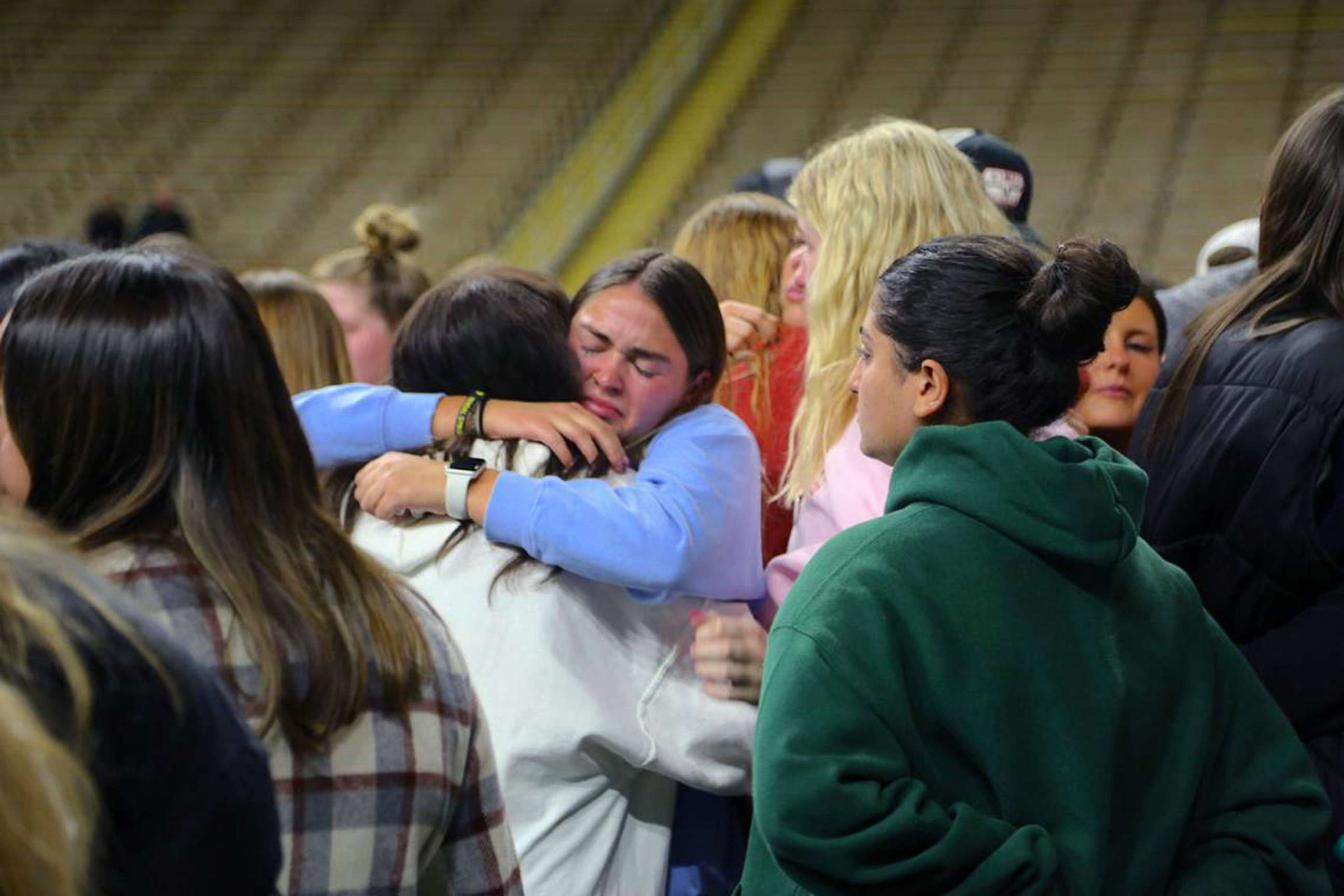 PHOTO: Attendees embrace at a vigil in Moscow, Idaho, honoring the lives of four slain University of Idaho students, March 15, 2023.