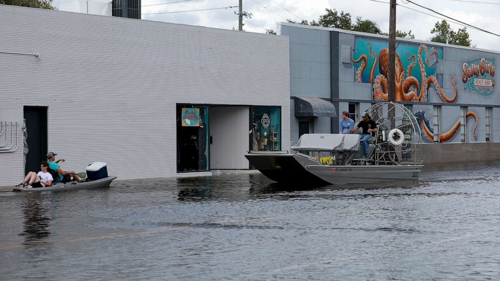 PHOTO: Kayakers and an airboat cruise down a flooded street after Hurricane Idalia passed offshore on Aug. 30, 2023, in Crystal River, Fla. Hurricane Idalia hit the Big Bend area on the Gulf Coast of Florida as a Category 3 storm.