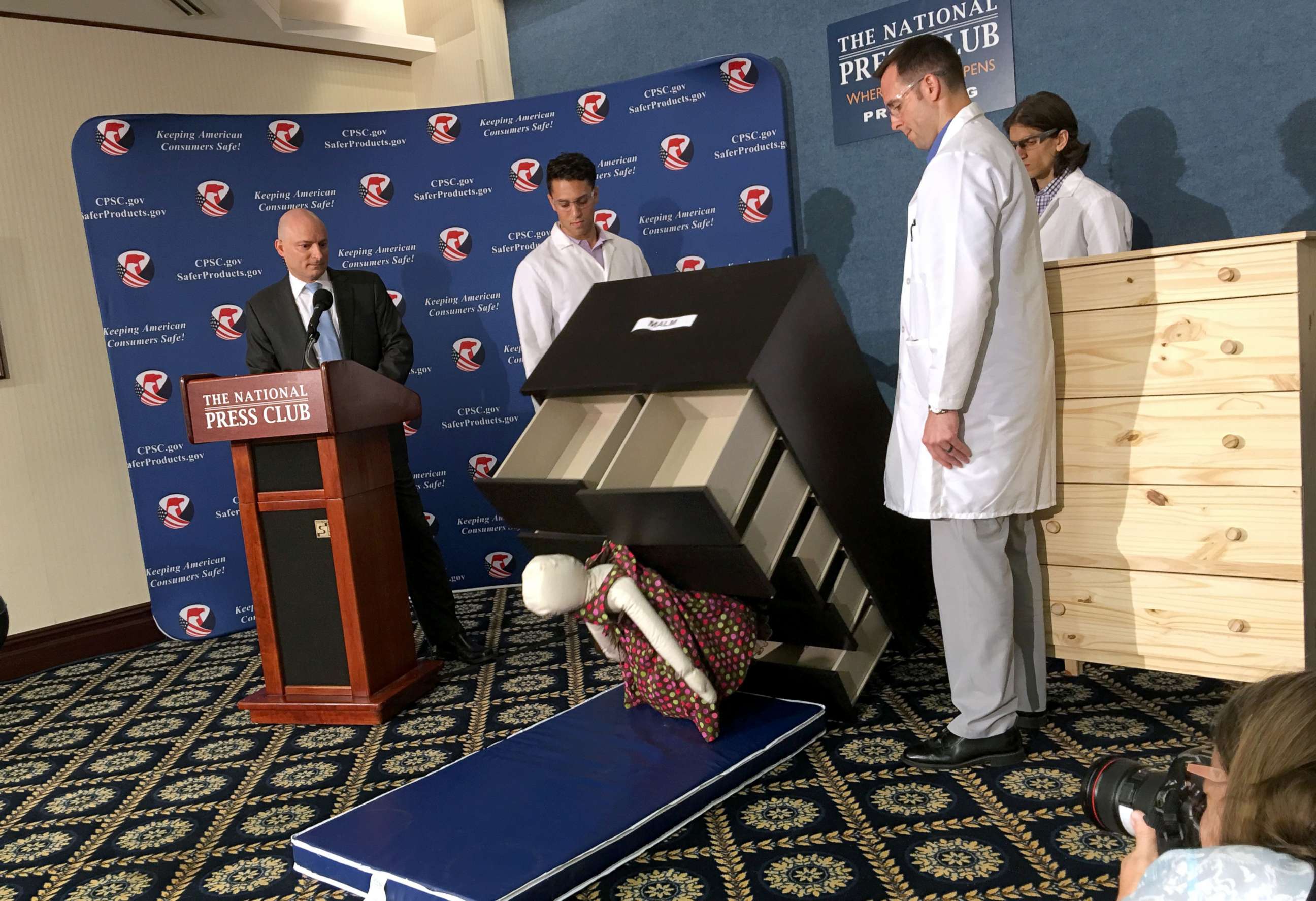 PHOTO: Consumer Product Safety Commission employees watch as a 28-pound dummy falls beneath IKEAs Malm model chest of drawers, during a live demonstration at the National Press Club in Washington, June 28, 2016.