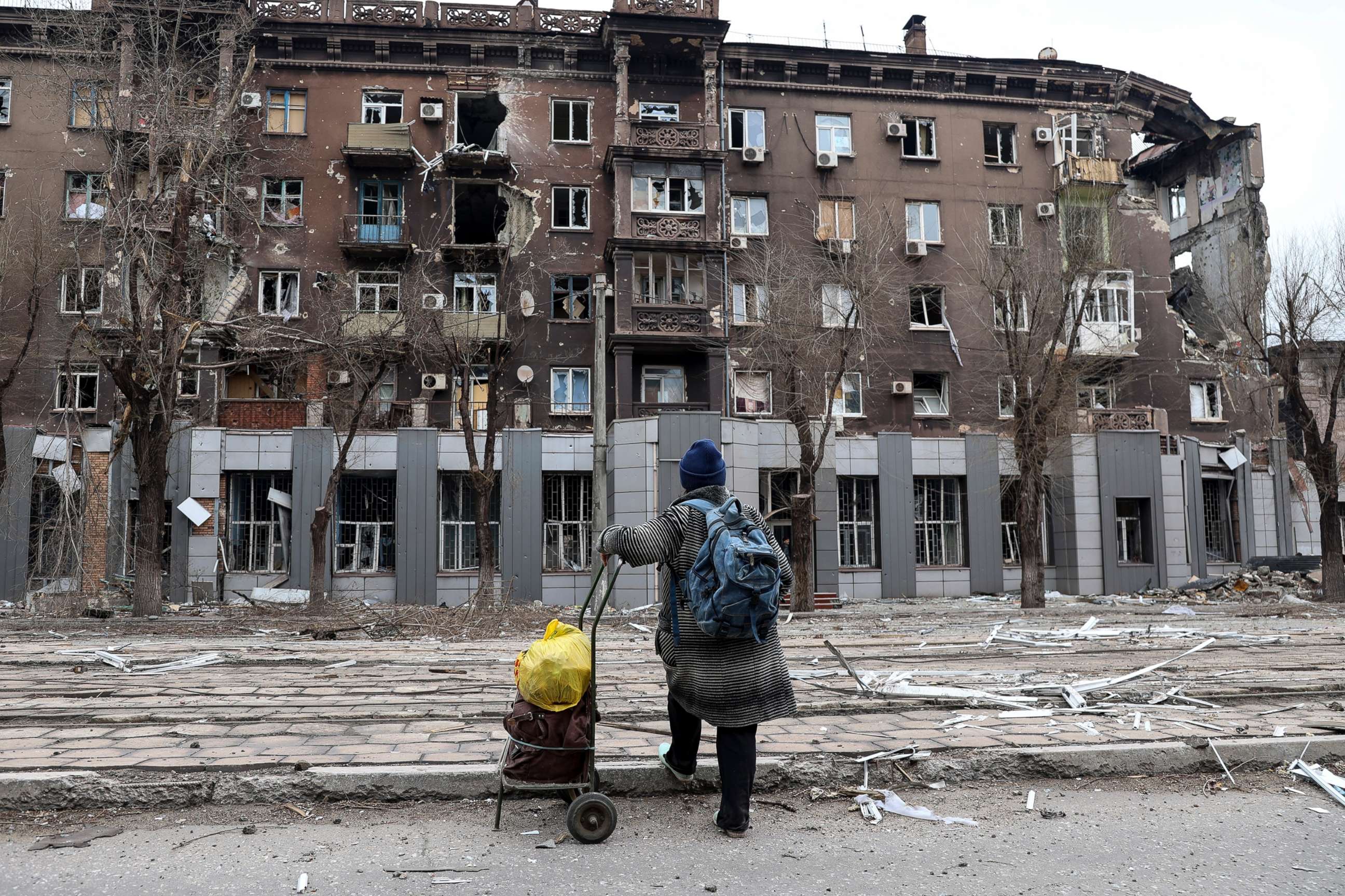 PHOTO: A resident looks at damage to an apartment building from heavy fighting near the Illich Iron & Steel Works Metallurgical Plant, in an area controlled by Russian-backed separatist forces in Mariupol, Ukraine, April 16, 2022.
