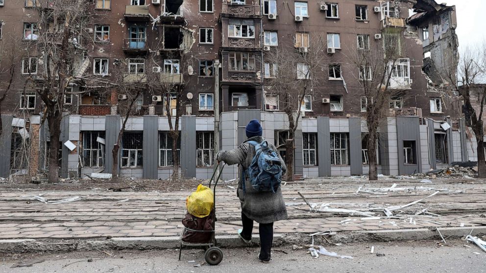 PHOTO: A resident looks at damage to an apartment building from heavy fighting near the Illich Iron & Steel Works Metallurgical Plant, in an area controlled by Russian-backed separatist forces in Mariupol, Ukraine, April 16, 2022.