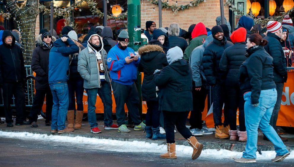 PHOTO: Customers wait in line outside Sunnyside Cannabis Dispensary to purchase recreational marijuana on Jan. 1, 2020, in Chicago.