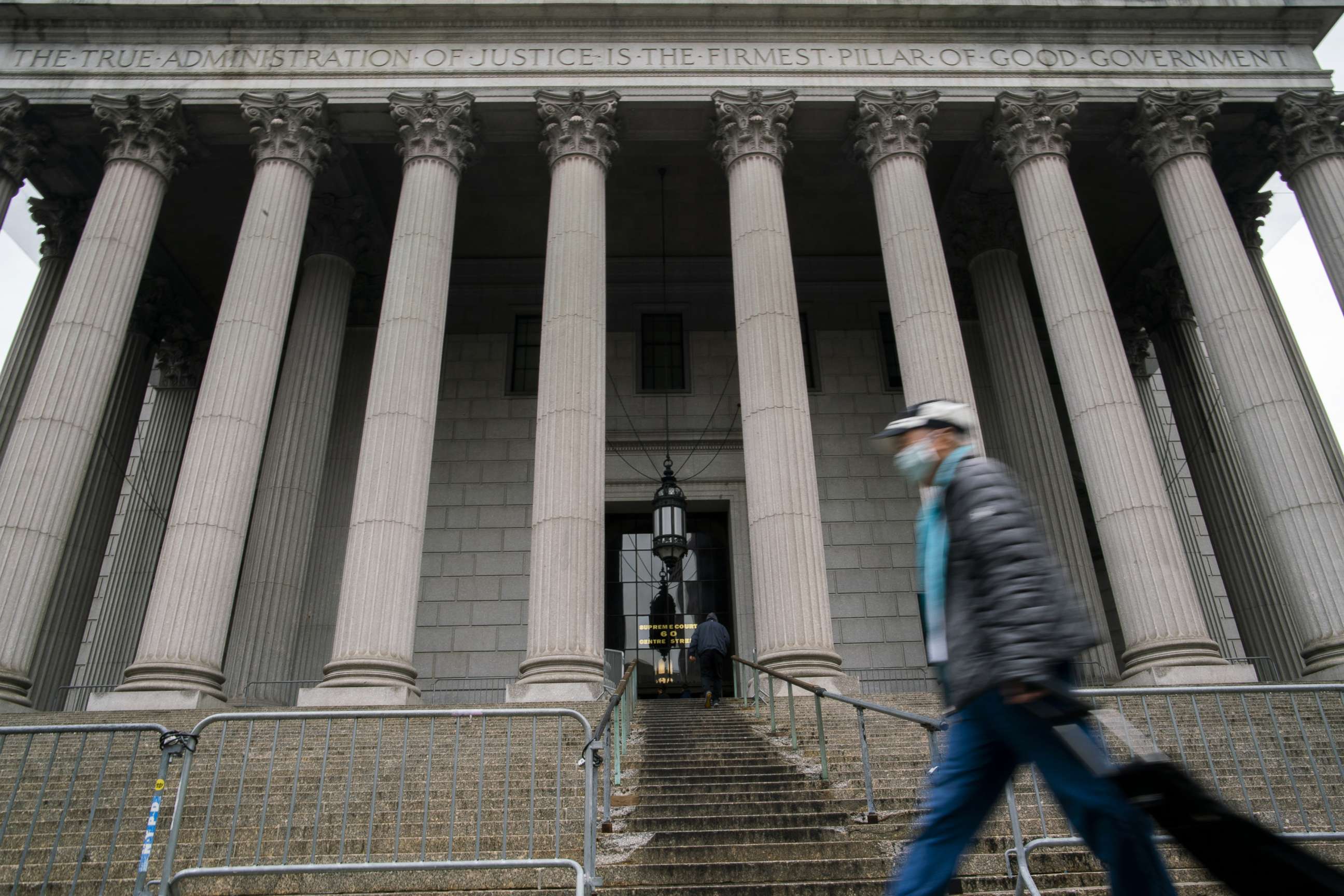 PHOTO: A man wearing a face mask passes by The New York State Supreme Court during the outbreak of coronavirus disease in New York, March 17, 2020.