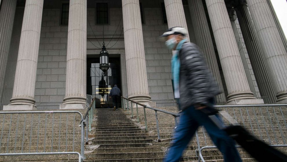 PHOTO: A man wearing a face mask passes by The New York State Supreme Court during the outbreak of coronavirus disease in New York, March 17, 2020.