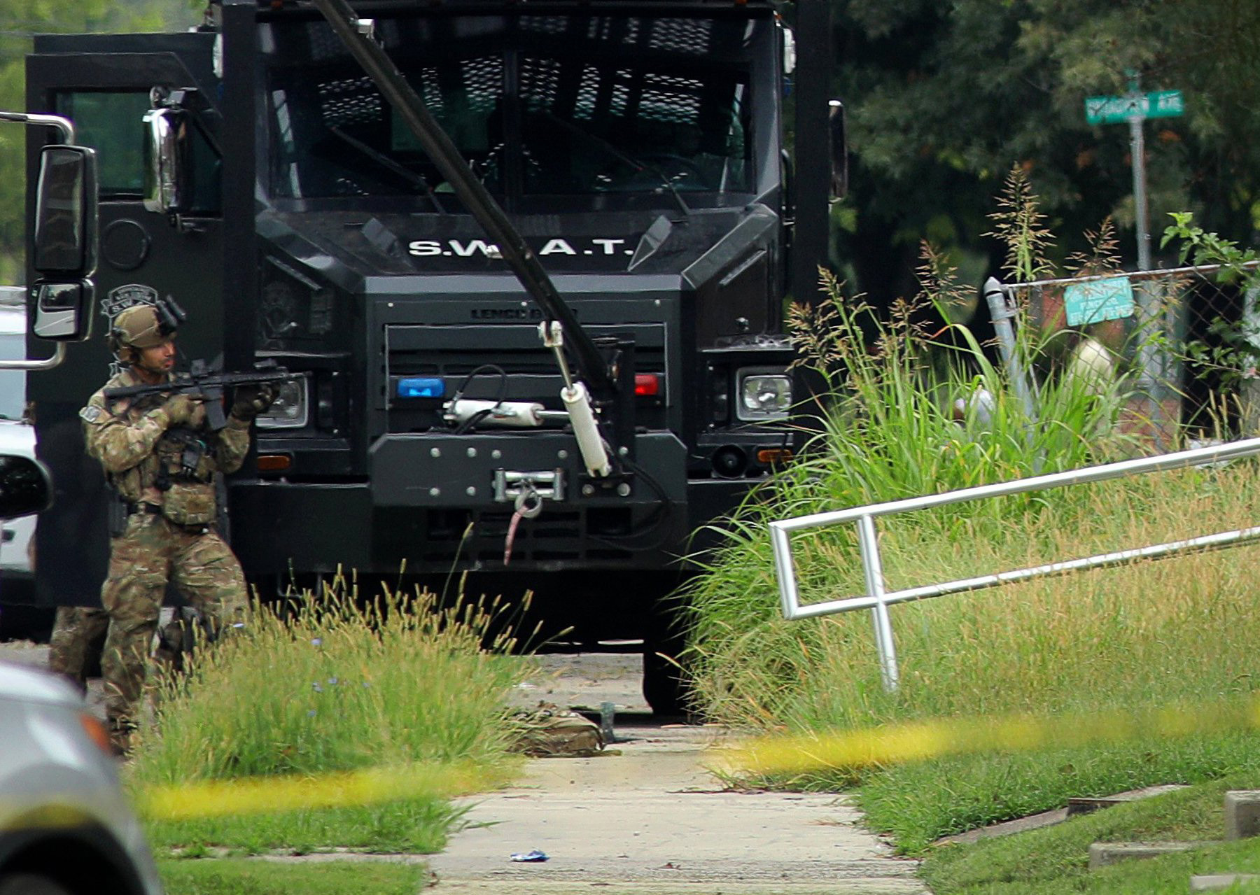 PHOTO: A police officer in tactical gear stands positioned near an Illinois State Police SWAT vehicle outside a building on 42nd Street near Van Buren Avenue, on Friday, Aug 23, 2019, in East St. Louis, Ill., after a trooper was shot serving a warrant.