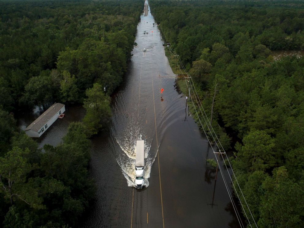 PHOTO: A truck drives through a flooded highway as flooding from the remnants of Tropical Storm Imelda continues in Southeast Texas, Sept. 20, 2019, in Mauriceville, Texas.