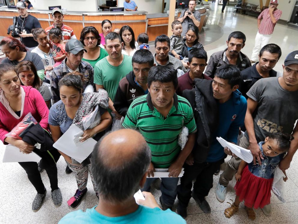 Immigrants listen to instructions from a volunteer inside the bus station after they were processed and released by U.S. Customs and Border Protection, Friday, June 22, 2018, in McAllen, Texas.
