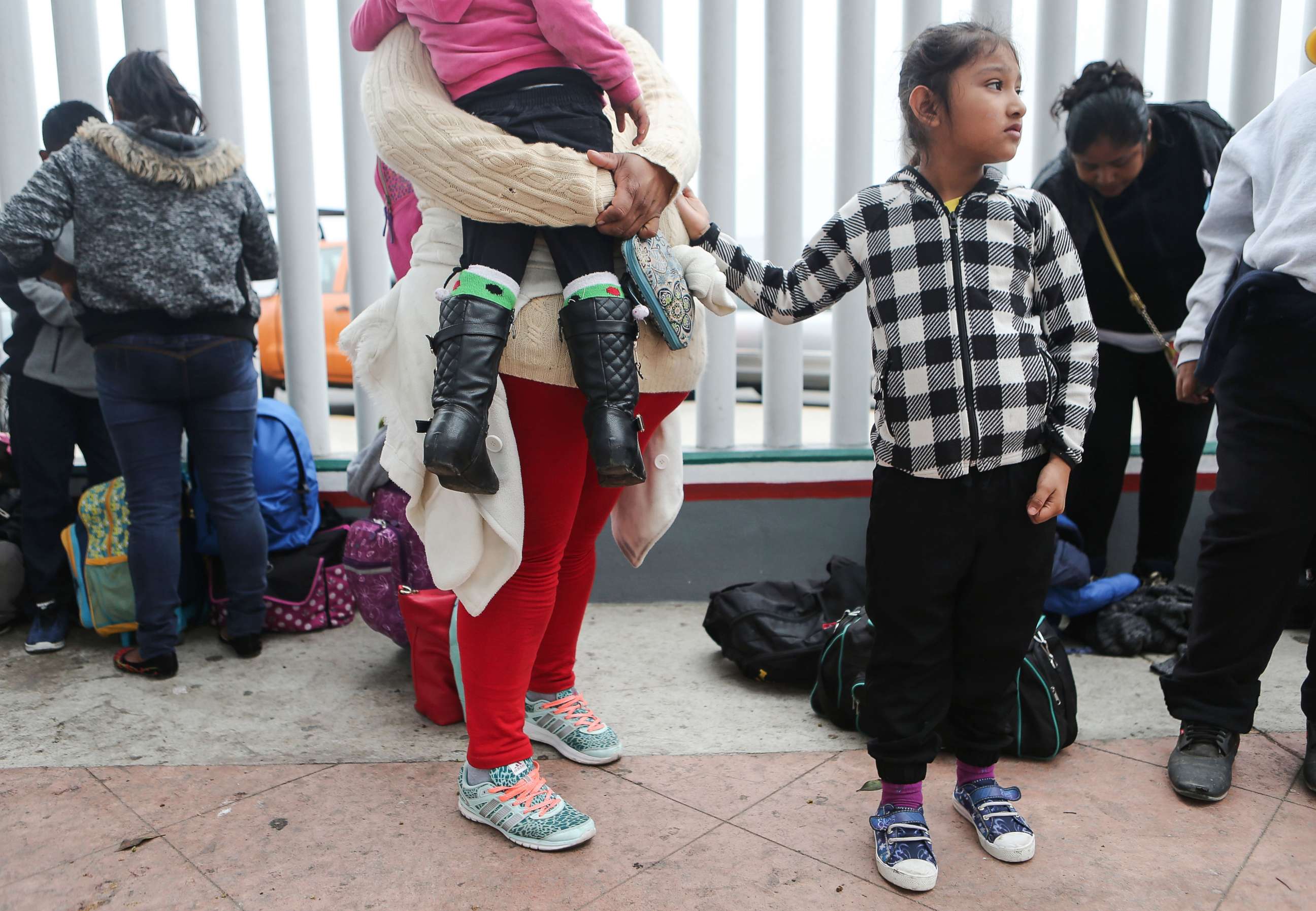 PHOTO: A migrant mother waits with her two daughters on their way to the port of entry to ask for asylum in the U.S., June 21, 2018, in Tijuana, Mexico.