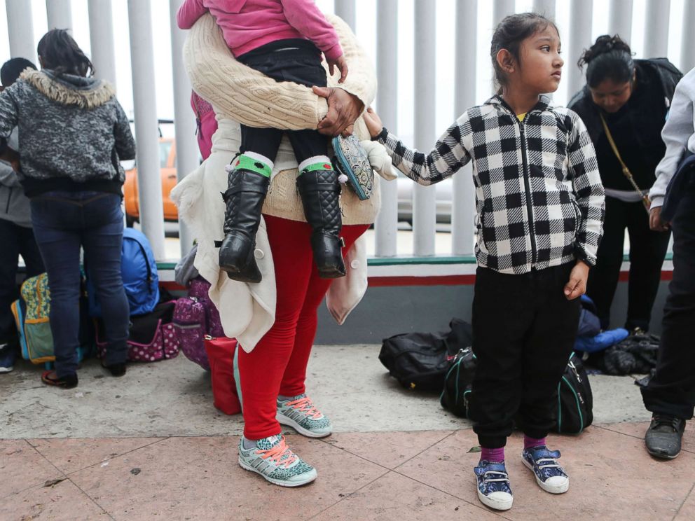 PHOTO: A migrant mother waits with her two daughters on their way to the port of entry to ask for asylum in the U.S., June 21, 2018, in Tijuana, Mexico.