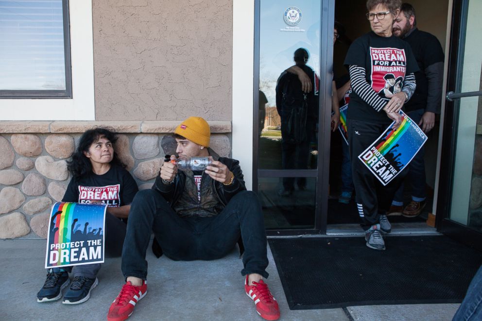 PHOTO: Alvarez talks with a member of her organization  after being locked out of both Congressmen Jason Lewis and Erik Paulsen's office during attempted sit-in protests.