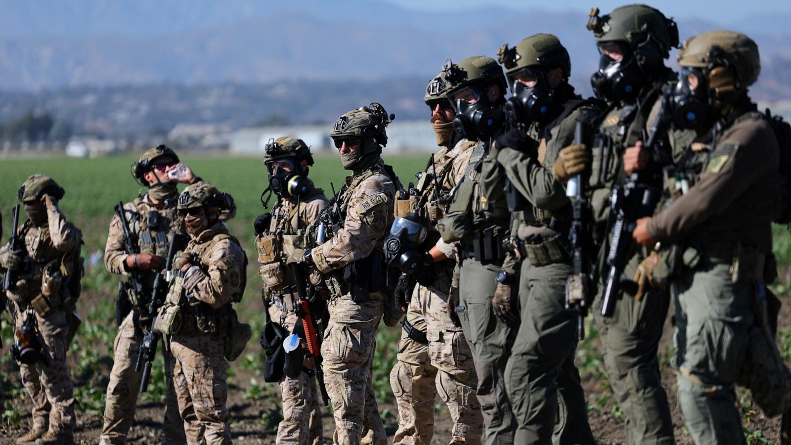 U.S. federal agents stand guard while blocking a road leading to an agricultural facility where U.S. federal agents and immigration officers carried out an operation, in Camarillo, California, U.S., July 10, 2025. 