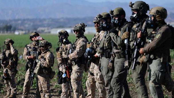 U.S. federal agents stand guard while blocking a road leading to an agricultural facility where U.S. federal agents and immigration officers carried out an operation, in Camarillo, California, U.S., July 10, 2025. 