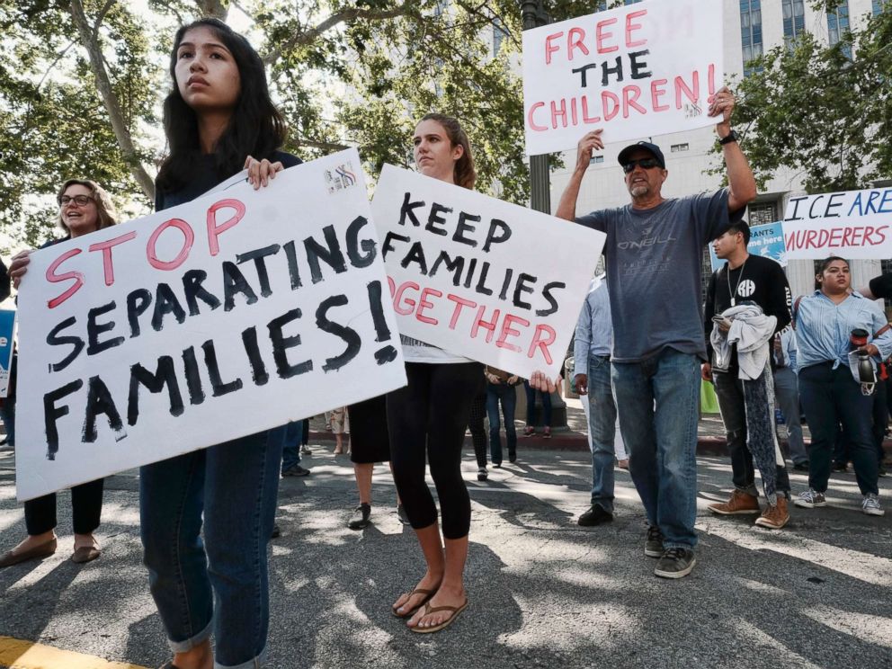 PHOTO: Protesters carry signs and chant slogans in front of Federal Courthouse in Los Angeles, June 26, 2018.