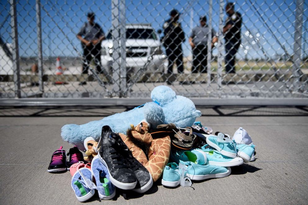 PHOTO: This June 21, 2018 file photo shows security personal standing before shoes and toys left at the Tornillo Port of Entry in Tornillo, Texas, where minors crossing the border without proper papers have been housed after being separated from adults.