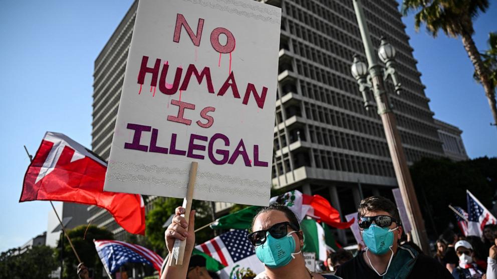 PHOTO: A person holds up a sign during ongoing demonstrations in response to federal immigration operations near Los Angeles City Hall in downtown Los Angeles on June 12, 2025.