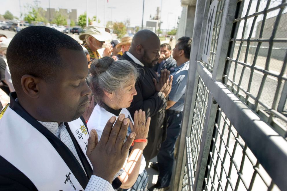 PHOTO: Clergy from different faiths pray at the front gate of the Otay Mesa Detention Center during a rally in support of immigrant families that had been separated at the US-Mexico border in San Diego, Calif. June 23, 2018.