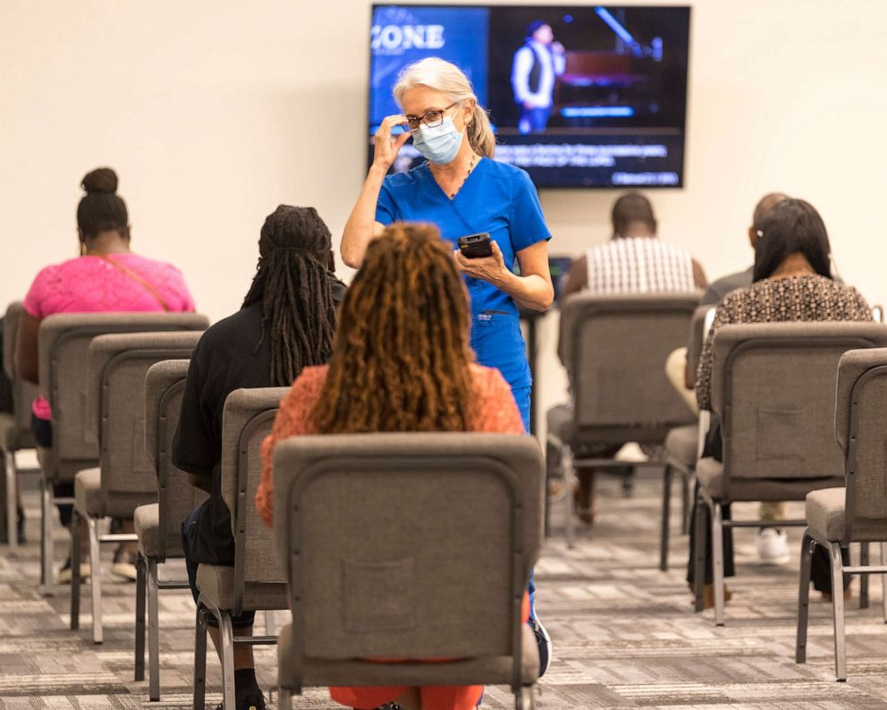 PHOTO: In this photo provided by Impact Church, people wait for a COVID-19 vaccination at an event held by Impact Church, Aug. 8, 2021, in Jacksonville, Fla.