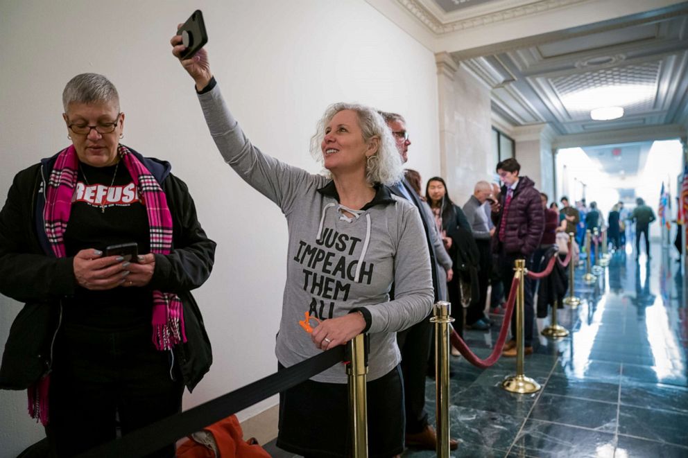 PHOTO: Jennifer Fisher, center, and Cathy Marino-Thomas, left, both of New York City, wait in line to attend a hearing by the House Judiciary Committee on Capitol Hill in Washington, Dec. 4, 2019.