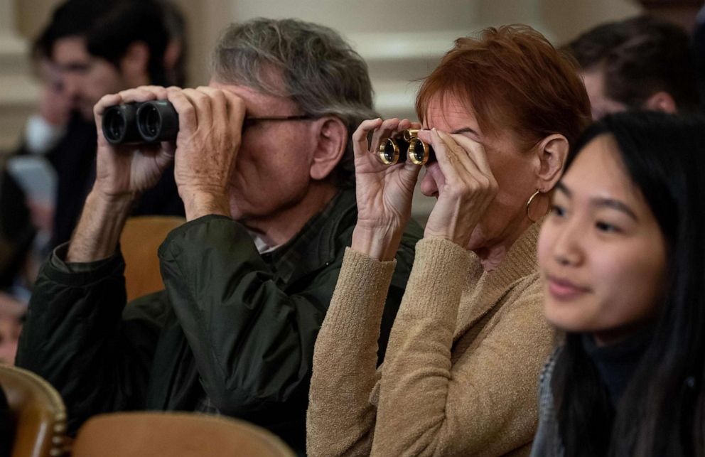 PHOTO: Members of the public use binoculars as they watch the House Judiciary Committee hearing on the impeachment of President Donald Trump on Capitol Hill in Washington, Dec. 4, 2019.