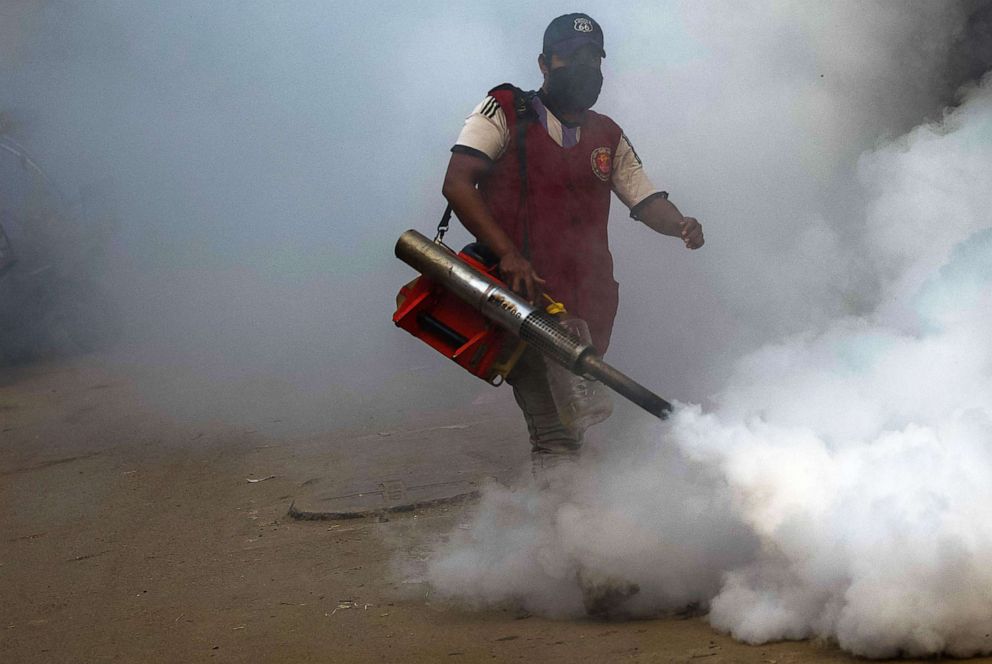 PHOTO: A municipal worker fumigates in a market area as a preventive measure against mosquito-bite-born diseases in Dhaka, India, on Jan. 4, 2022.