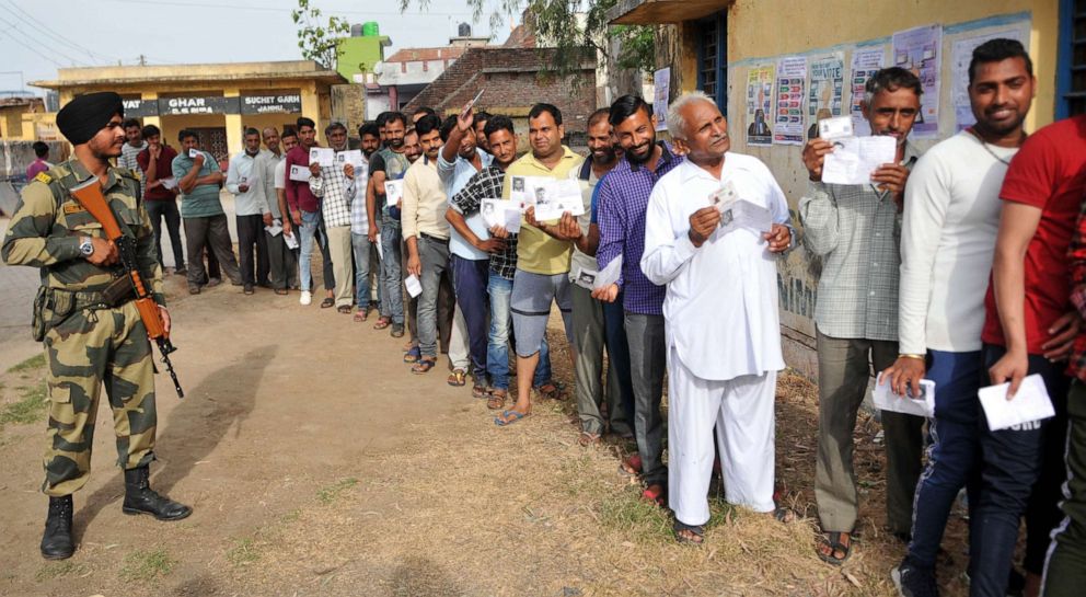 PHOTO: Voters stand in a queue to cast their votes at a polling booth for the first phase of general elections, April 11, 2019, in Jammu, India.