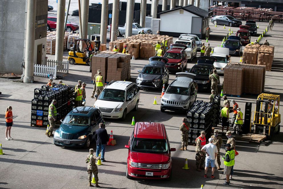 PHOTO: Vehicles move through a food distribution line at the Indianapolis Motor Speedway in Indianapolis, May 23, 2020, for a mobile food distribution event.