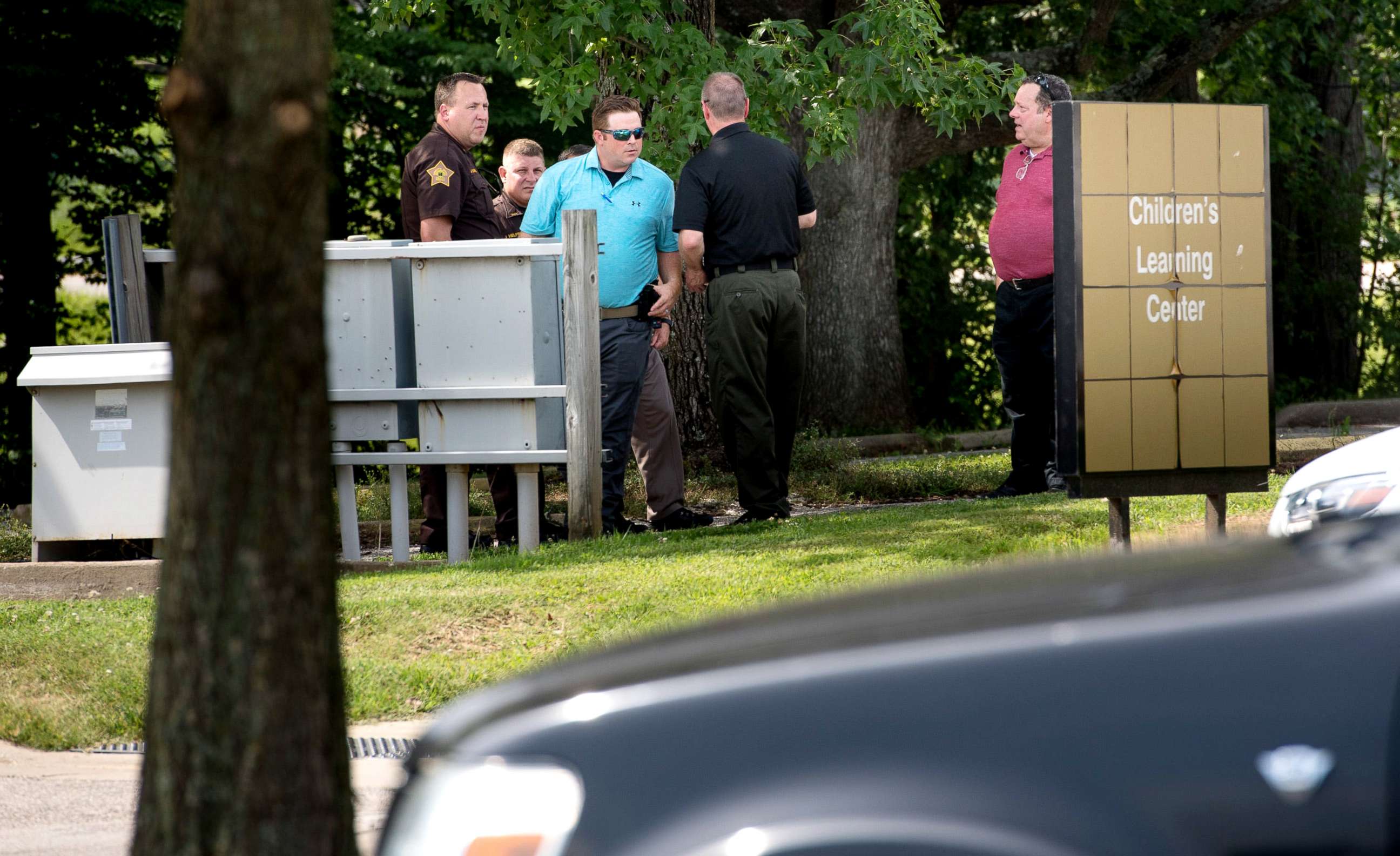 PHOTO: Members of the Vanderburgh County Sheriff's Office investigate the death of a child left in a hot car at the University of Southern Indiana's Children's Learning Center, July 9, 2019.
