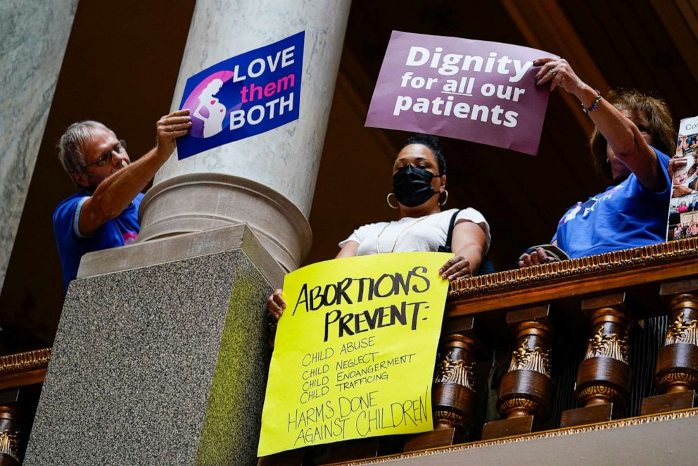 PHOTO: Anti-abortion supporters try to cover a sign of an abortion rights supporter during an anti-abortion during a hearing at the Statehouse in Indianapolis, July 26, 2022.