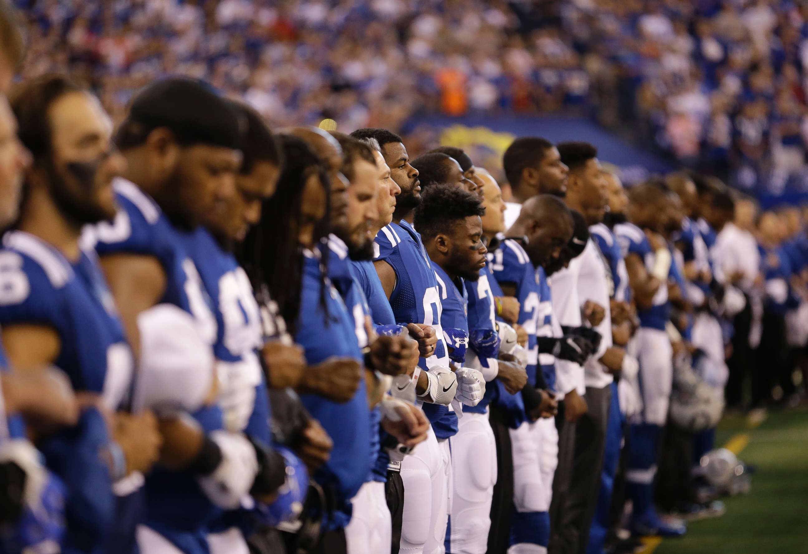 PHOTO: Members of the Indianapolis Colts lock arms during the playing of the national anthem before an NFL football game against the San Francisco 49ers, Oct. 8, 2017, in Indianapolis.