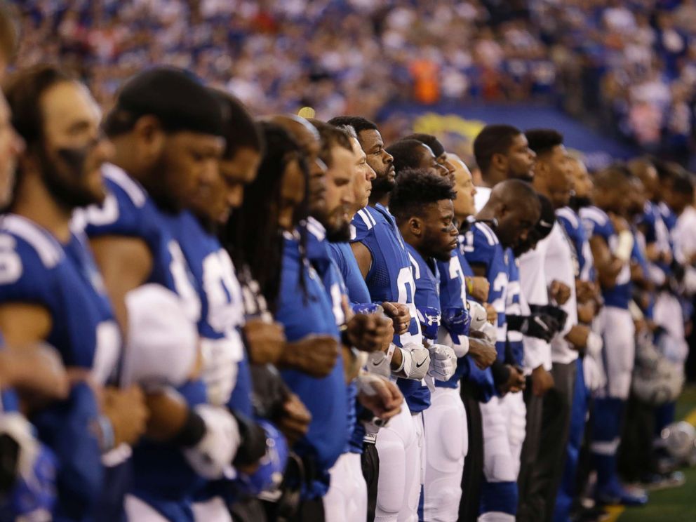 PHOTO: Members of the Indianapolis Colts lock arms during the playing of the national anthem before an NFL football game against the San Francisco 49ers, Oct. 8, 2017, in Indianapolis.