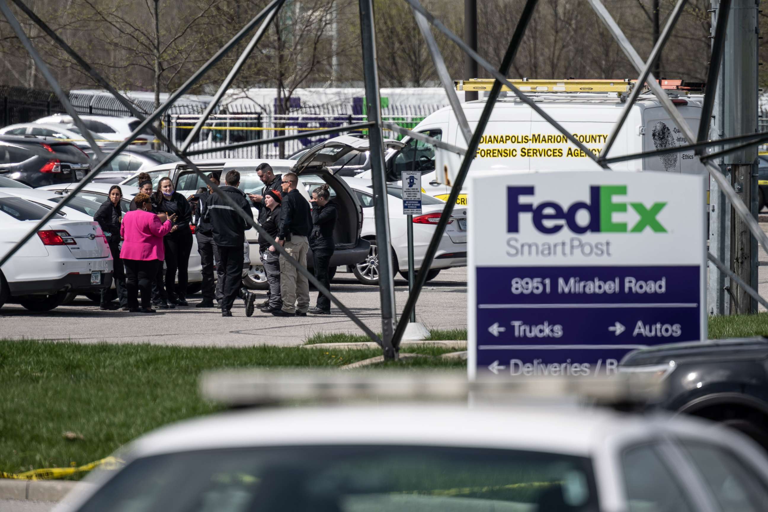 PHOTO: In this April 16, 2021, file photo, a group of crime scene investigators gather to speak in the parking lot of a FedEx SmartPost in Indianapolis.