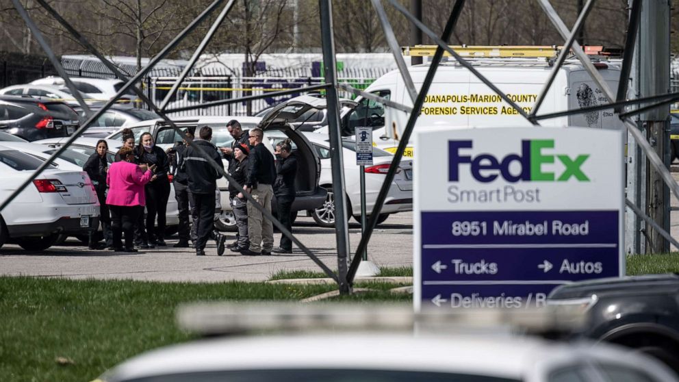 PHOTO: A group of crime scene investigators gather to speak in the parking lot of a FedEx SmartPost on April 16, 2021, in Indianapolis.