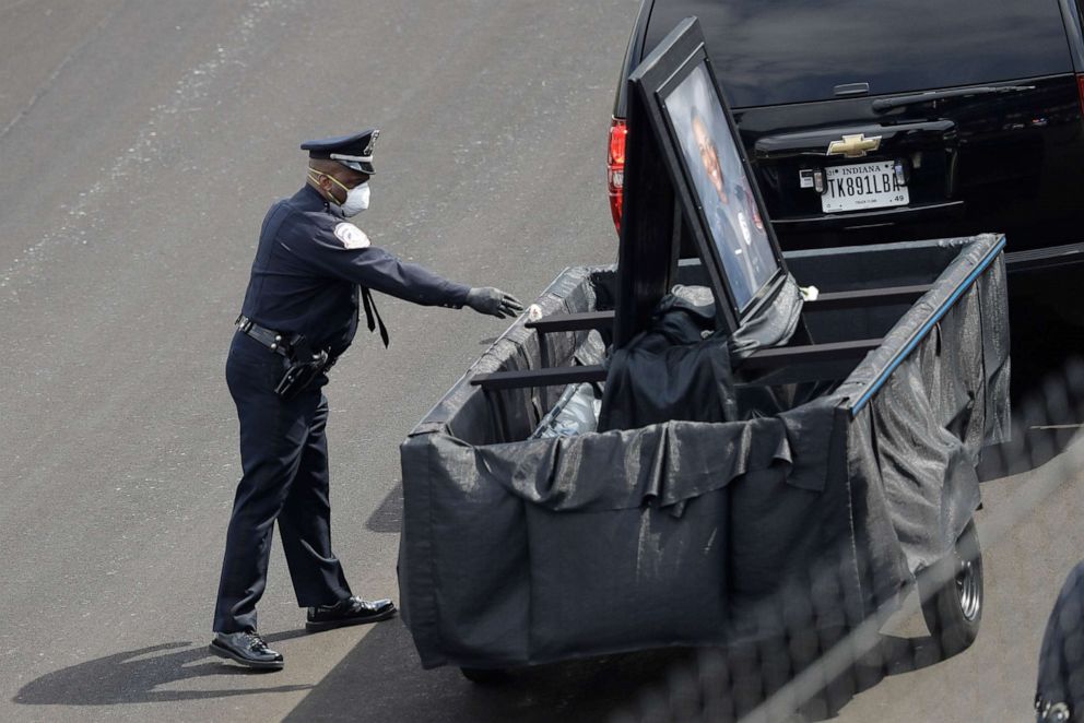 PHOTO: An officer places a carnation in a trailer to honor Indianapolis Metropolitan Police Department officer Breann "Bre" Leath following a funeral service at the Indianapolis Motor Speedway, Thursday, April 16, 2020, in Indianapolis.