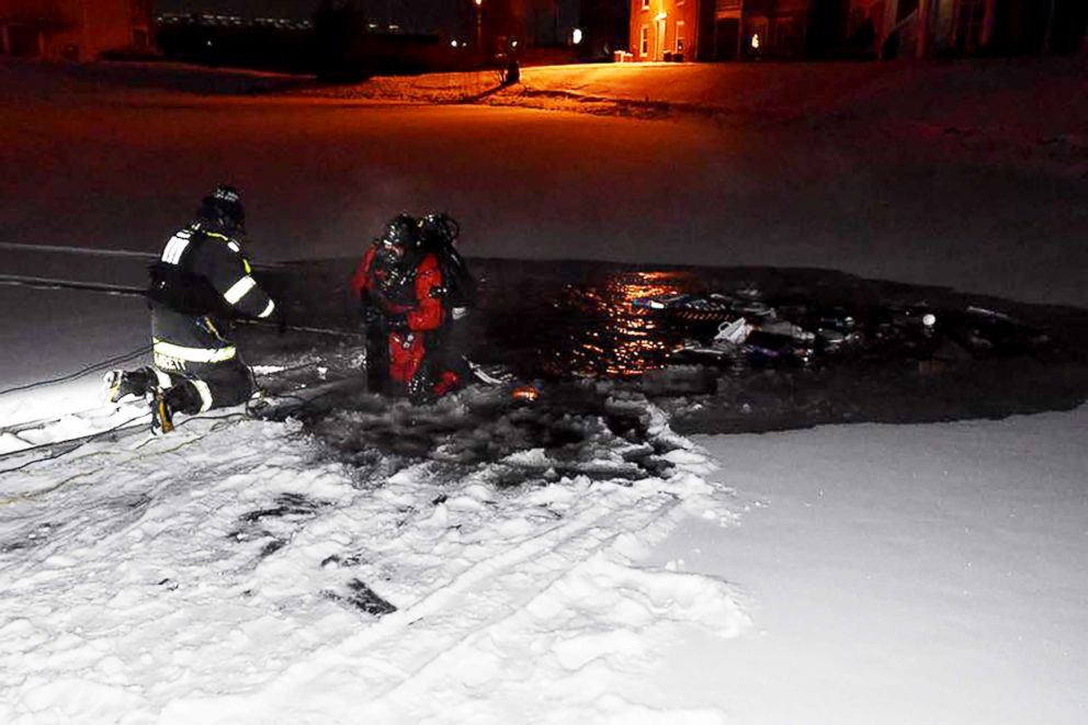 PHOTO: Fire crews raced to rescue a woman from her submerged car after she drove into an icy pond at an apartment complex in Indianapolis, Ind. 