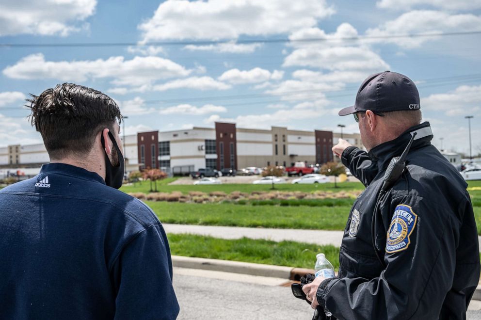 PHOTO: A FedEx employee speaks with a police officer about details relating to his place of work, a FedEx Ground facility, on April 16, 2021, in Indianapolis.