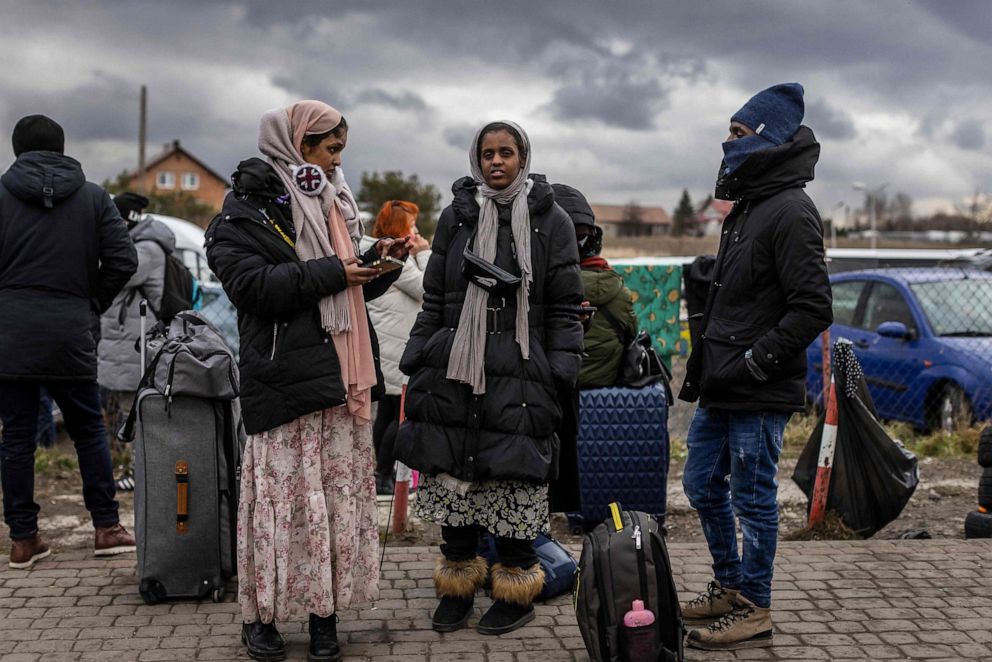 PHOTO: Indians wait for transport as refugees from many different countries - mostly students of Ukrainian universities - arrive at the Medyka pedestrian border crossing fleeing the conflict in Ukraine, in eastern Poland on Feb. 27, 2022.